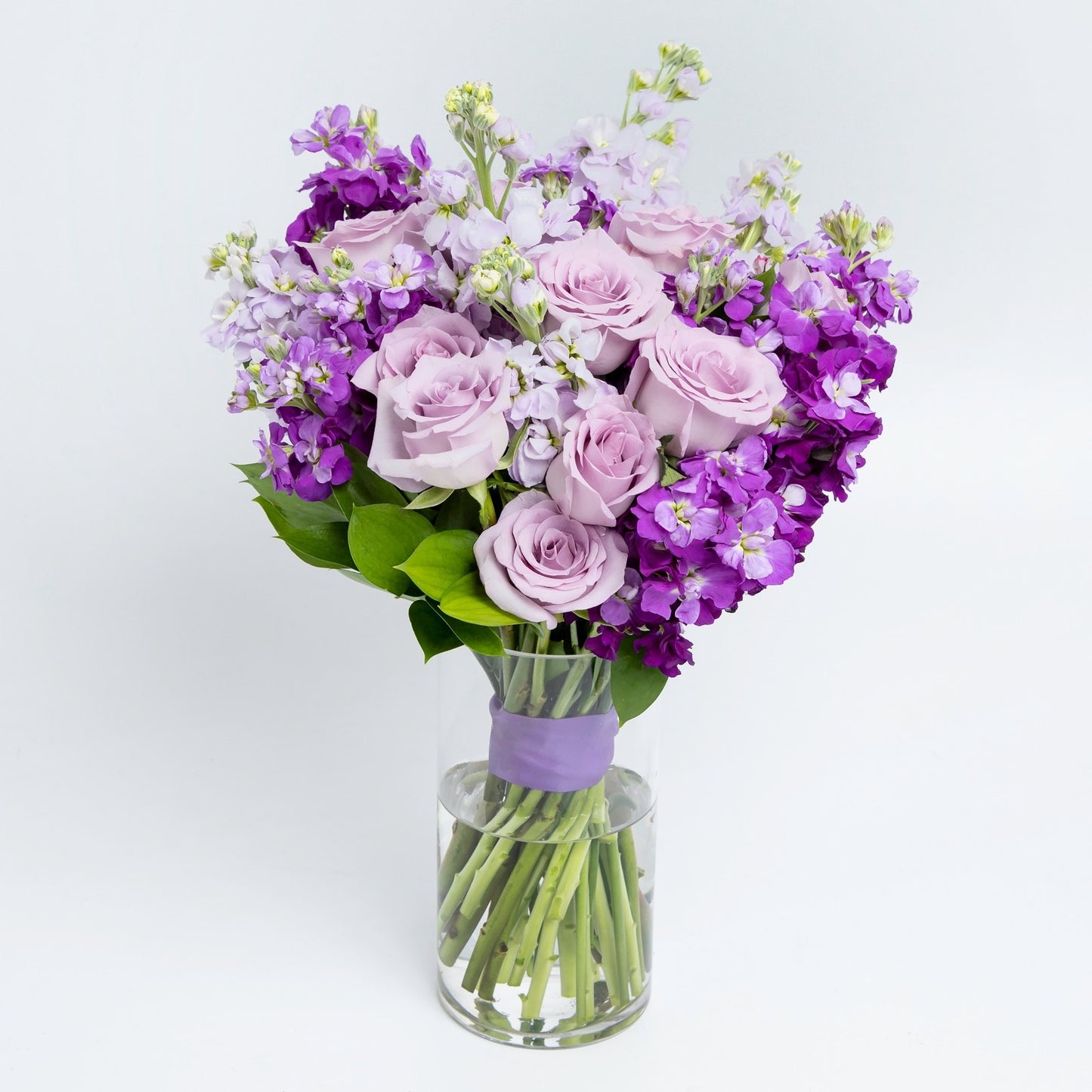 Purple roses & stock with vase